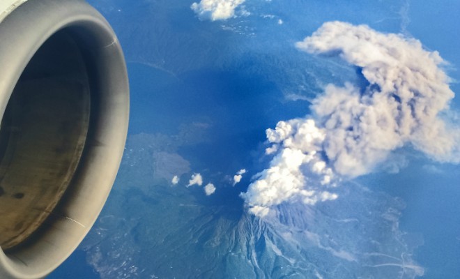 Plane flying over volcano.